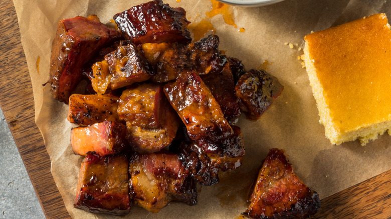 Burnt ends on parchment paper with corn bread