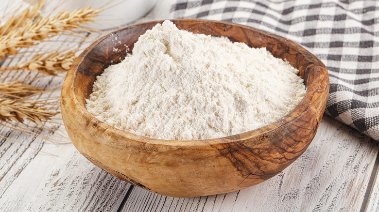 Wooden bowl full of white flour