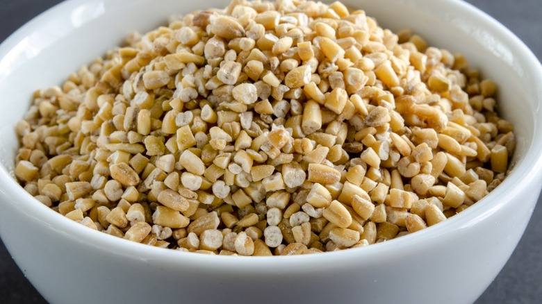 Close up of raw steel cut oats oat in a white bowl