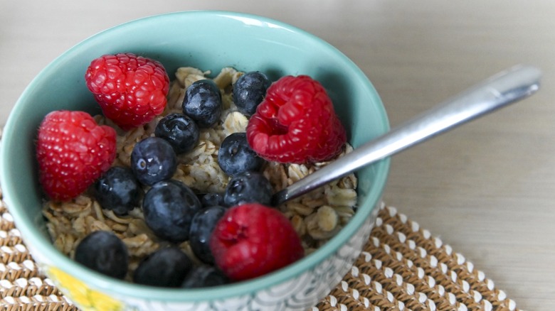 Healthy oatmeal with fresh blueberries and raspberries in a bowl