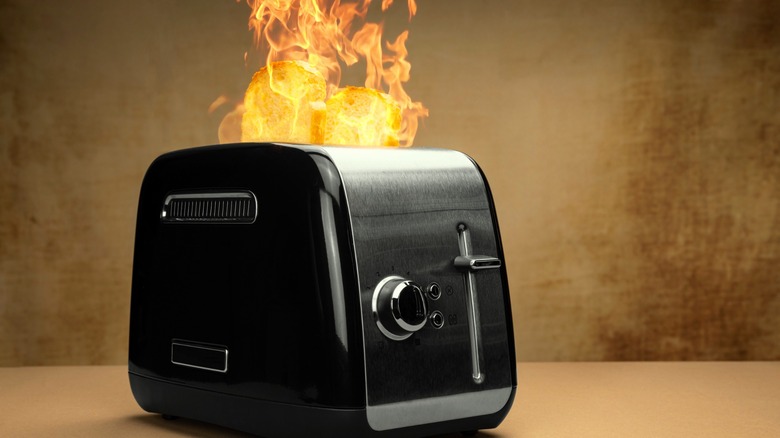 Toaster with flames rising from bread slots