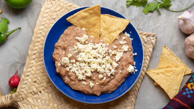Traditional Mexican refried beans with cheese and totopos