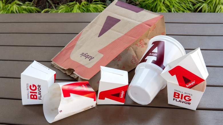 A table of empty Arby's food packaging