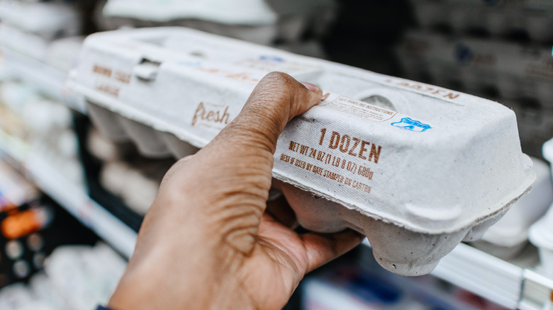 hand holding egg carton in store