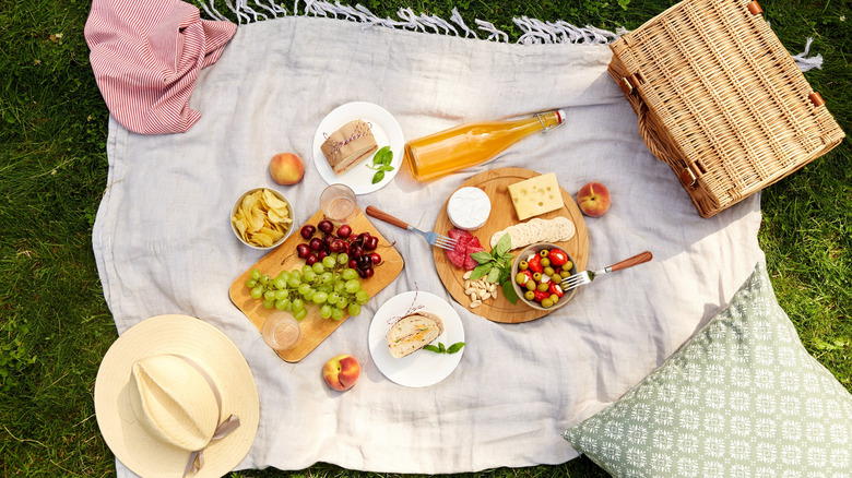 summer picnic set up with fruits, crackers, and cheese