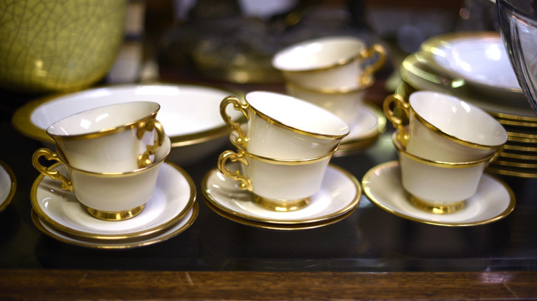 A set of gold-plated tea cups and saucers