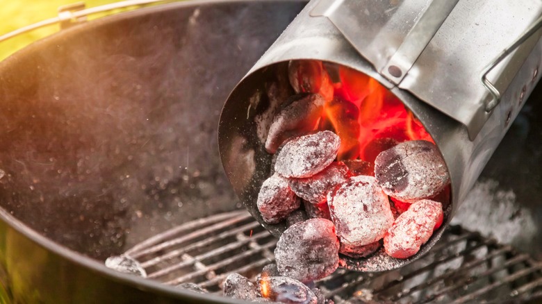 Dumping a load of hot charcoal into a grill