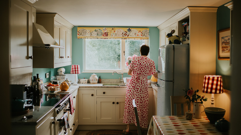 Someone cooking in a quaint kitchen.