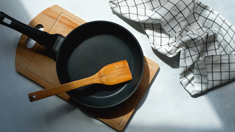 Cast iron skillet sitting atop a wooden cutting board