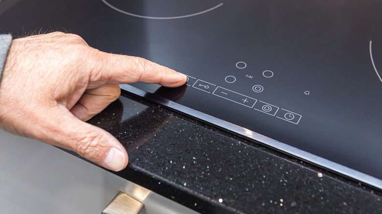 Someone operating an induction stove