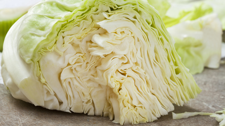 A steel colander filled with head of quartered cabbage wedges