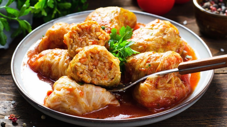 Cabbage rolls on white plate with fork