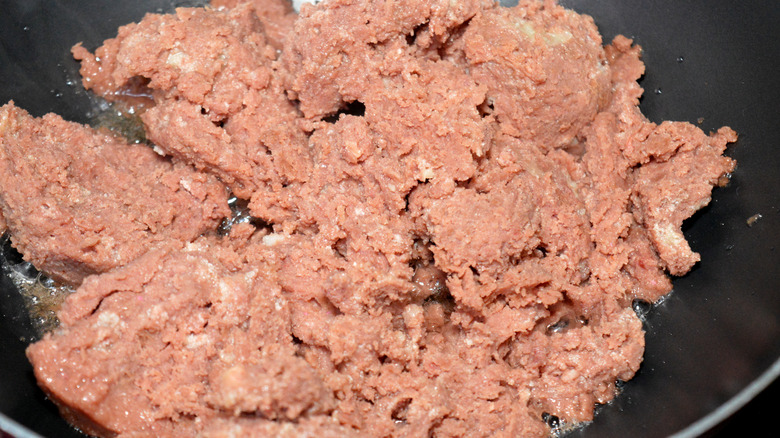Close-up of corned beef cooking in a skillet