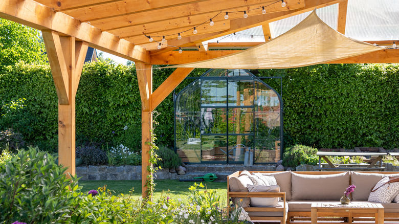 A wooden covered terrace with furniture in an outdoor space