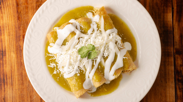 Green enchiladas on a white plate