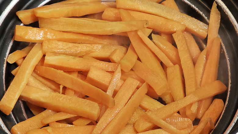 Carrot sticks in steamer basket