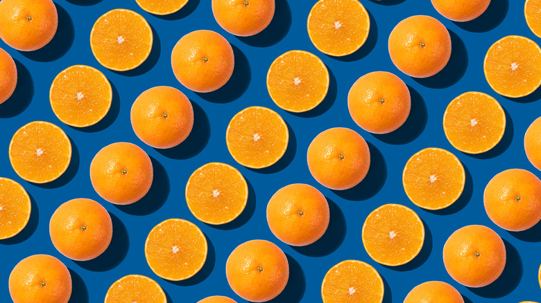 An aesthetic design of cut and whole oranges