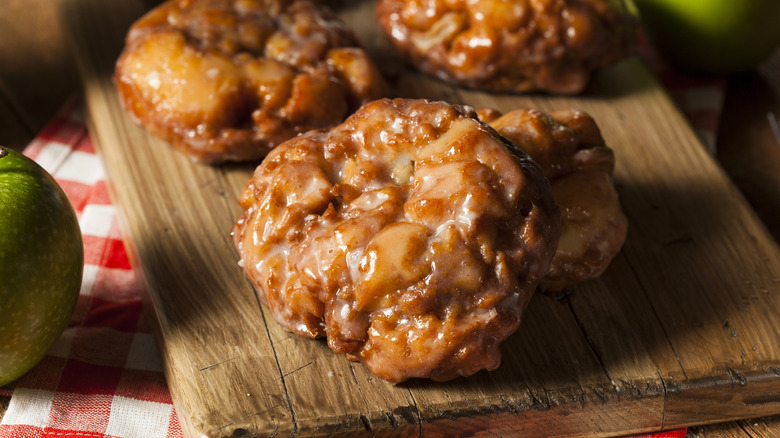 Apple fritters on a wooden board