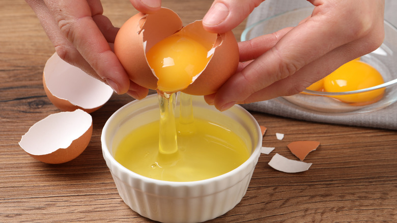 woman cracking egg into bowl
