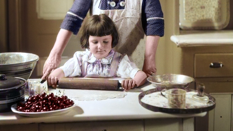 Vintage picture of a girl cooking with her grandmother
