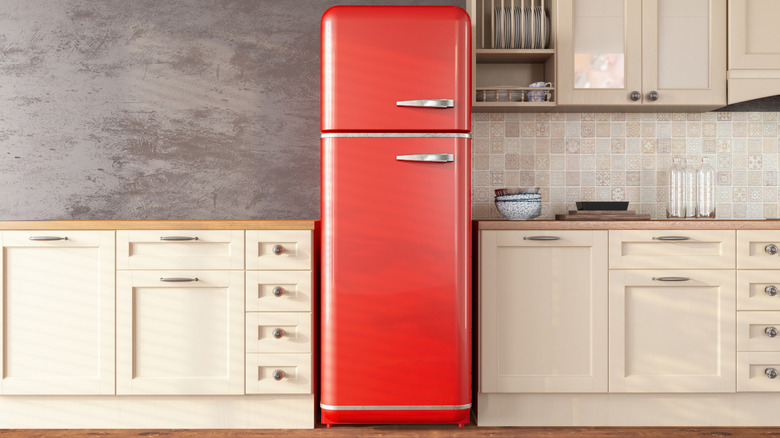 A red refrigerator in a white kitchen