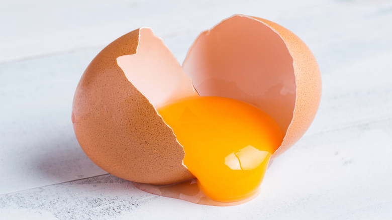 yolk spilling out of broken egg