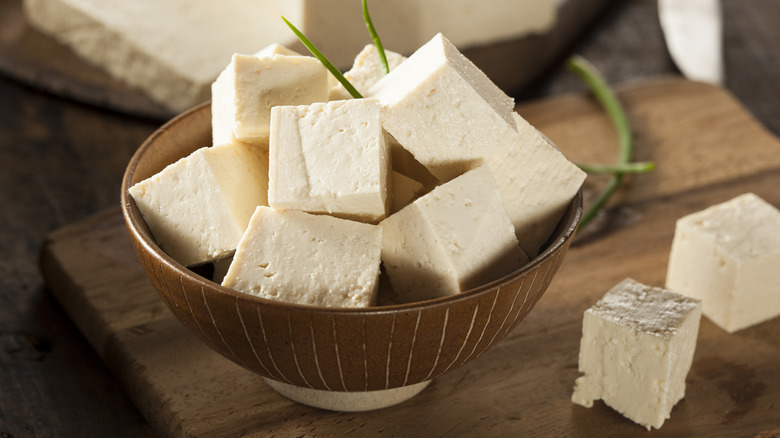 cubes of raw tofu in a brown bowl