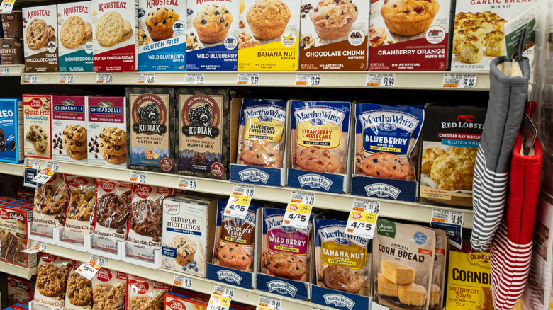 Boxes and bags of muffin mix varieties in the baking aisle of a grocery store