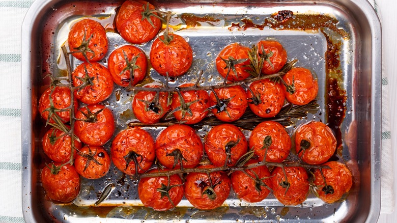 Roasted tomatoes on vine in baking tray