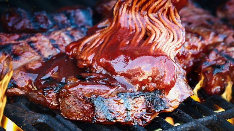 Up close meat mopped with BBQ sauce