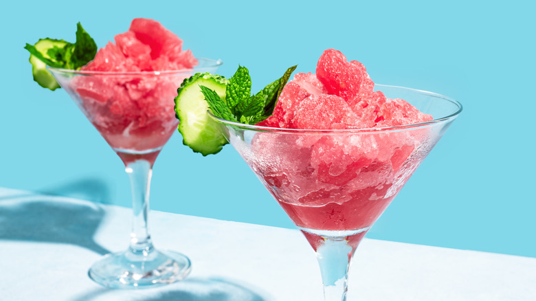 Red granita in a glass garnished with mint and cucumber