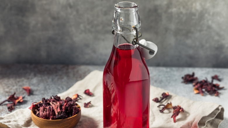 Homemade hibiscus simple syrup in a glass jar