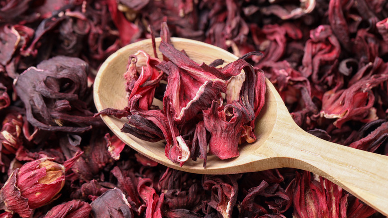 Dried hibiscus flowers in a wooden spoon