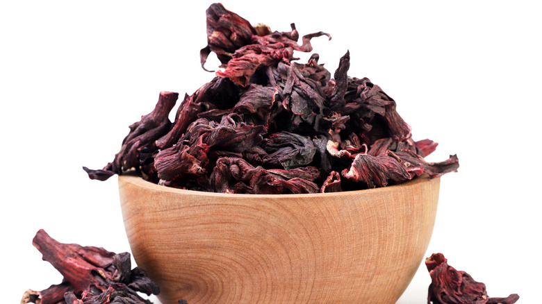 Dried hibiscus leaves in a wooden bowl