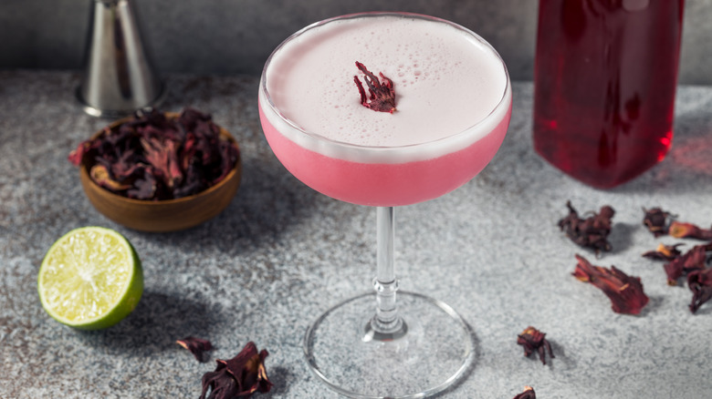A cocktail made and garnished with hibiscus