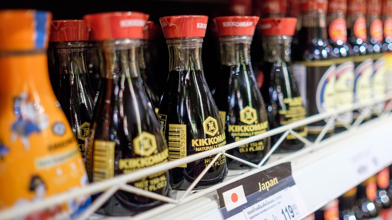 Kikkoman double spout soy sauce bottles on a grocery shelf