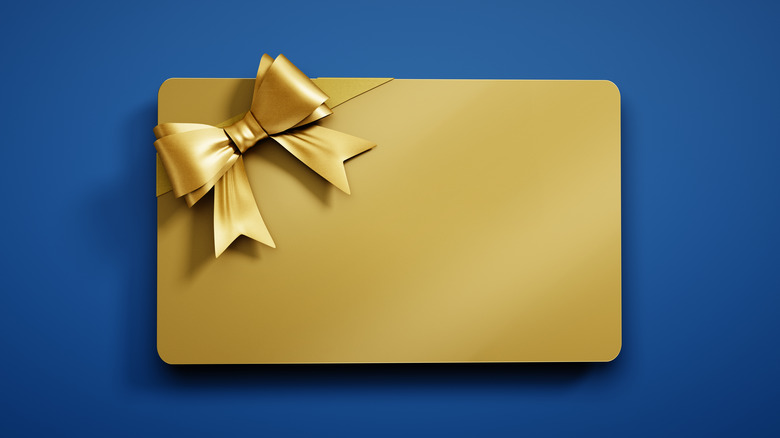 A plain, gold gift card on a blue background