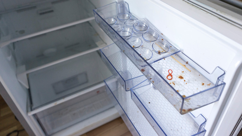 Dirty interior of an empty fridge