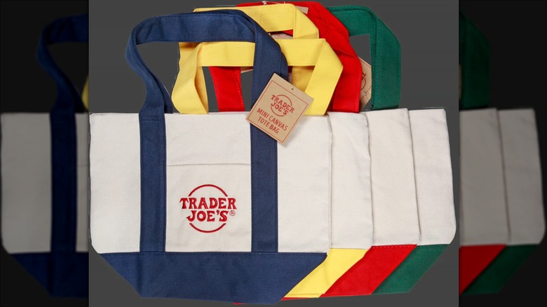 Trader Joe's mini canvas tote bags in navy, yellow, red, and green