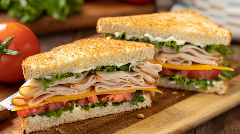 Turkey sandwich on toasted bread cut in half