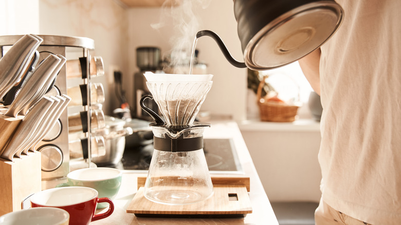 Person making pour over coffee at home