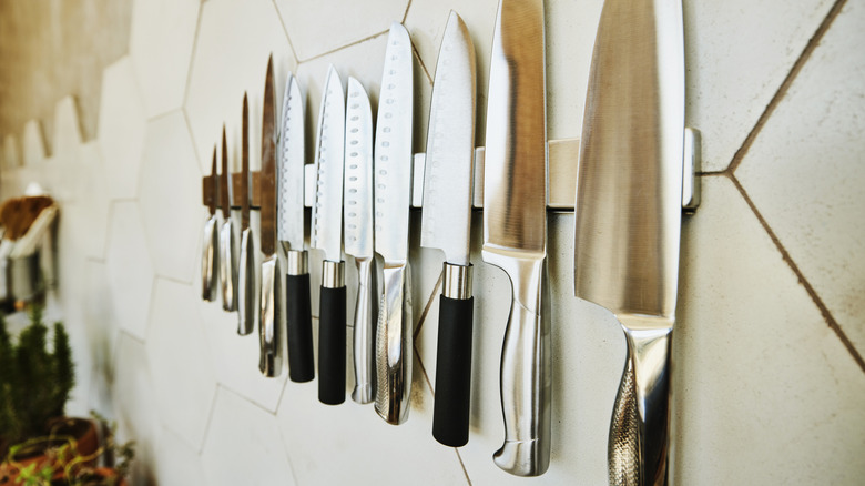 Kitchen knives attached to a wall magnet