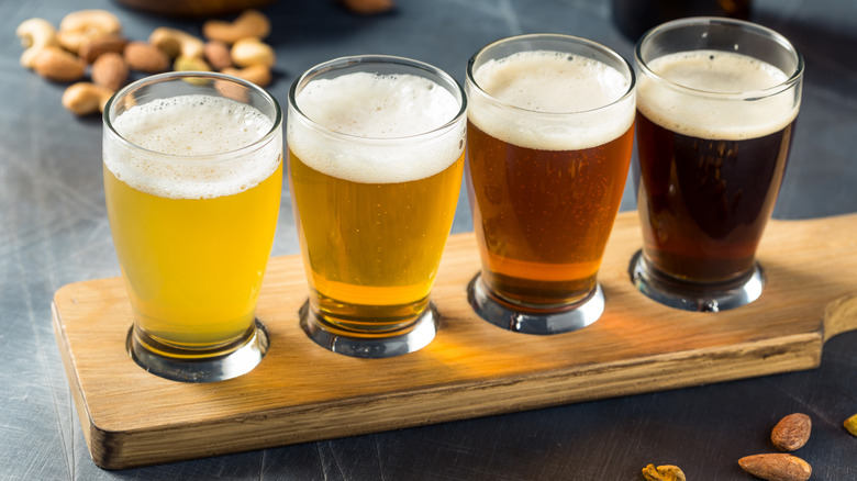 A beer flight with pours from light to dark