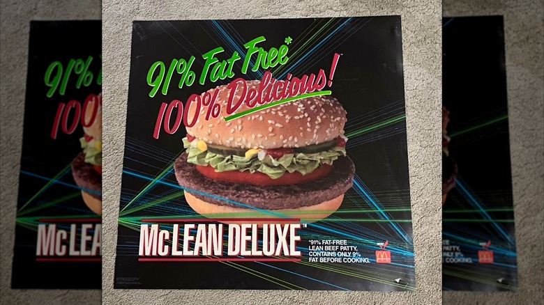 A vintage translite sign promoting the McLean Deluxe