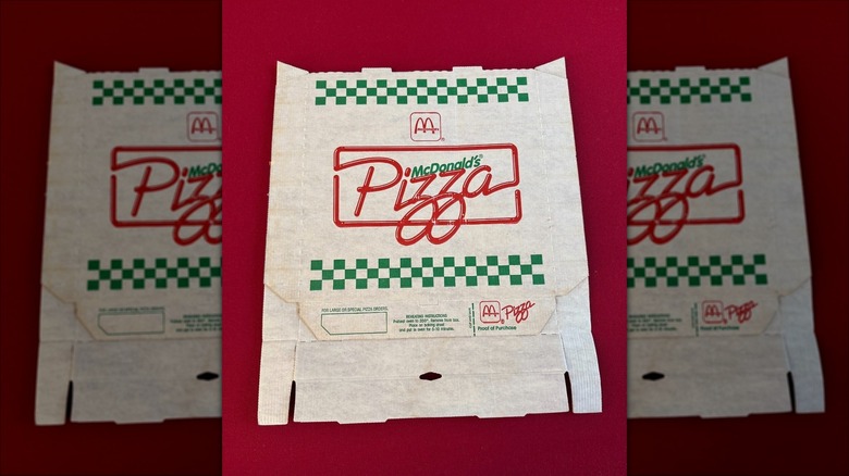 A flattened McDonald's Pizza Box against a red background