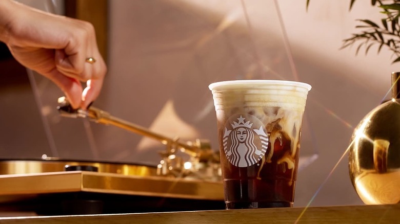 a Starbucks' Oleato next to a record player