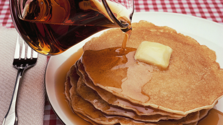maple syrup poured on pancakes