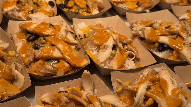 Rows of Chicken Teriyaki Bowls in cardboard takeout containers