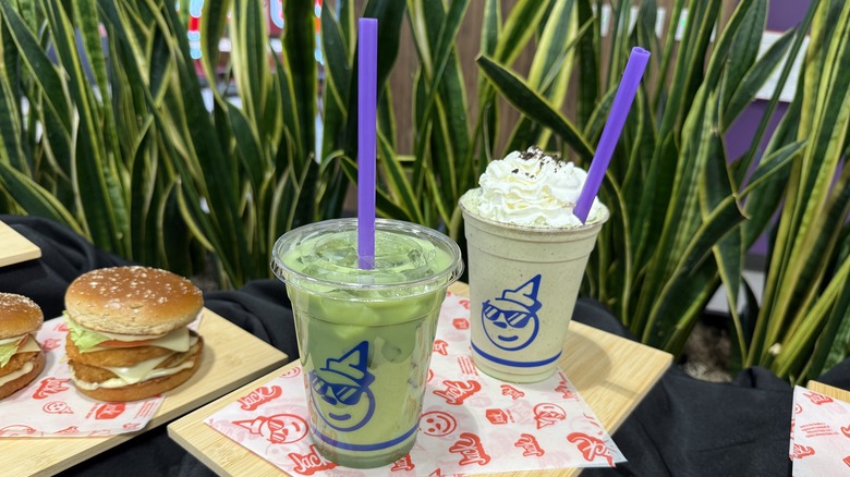 Jack in the Box Matcha drinks with big straws, one iced and another shake with whipped topping