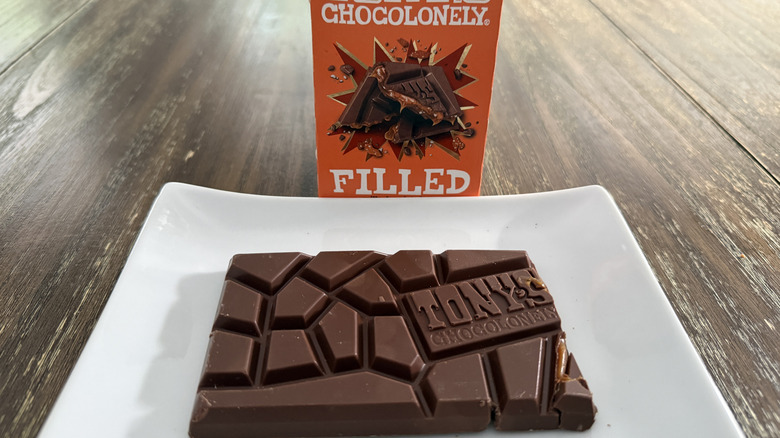 Tony's Chocolonely Filled Chocolate Bar on white plate on wooden table